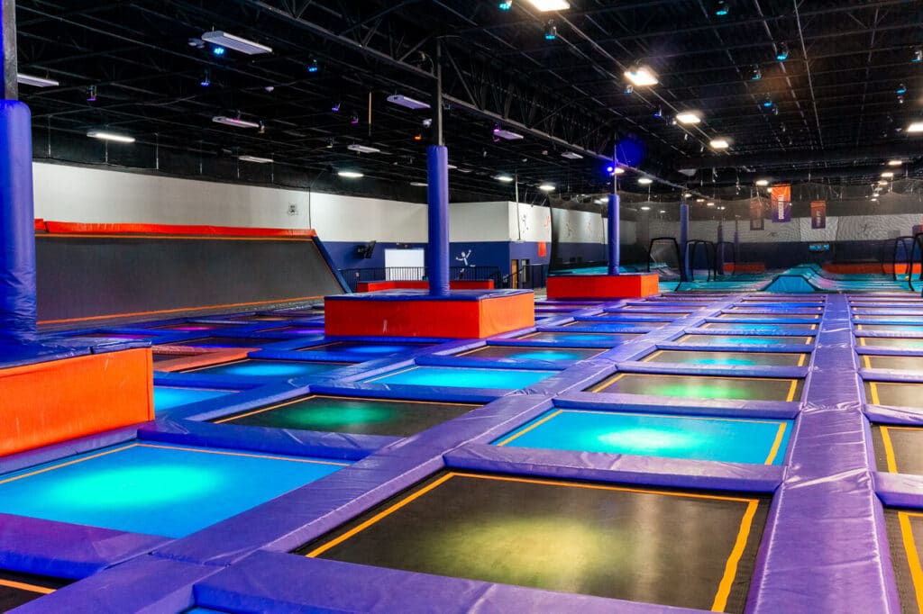 A court of trampolines that have glowing colors.