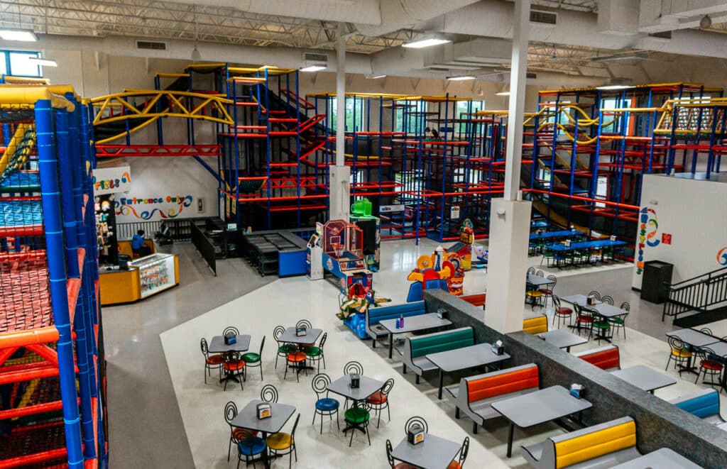 KidMania-an indoor playground in Dallas that hugs three walls, it's so big! With some booths, chairs, tables, and arcade games on the floor.