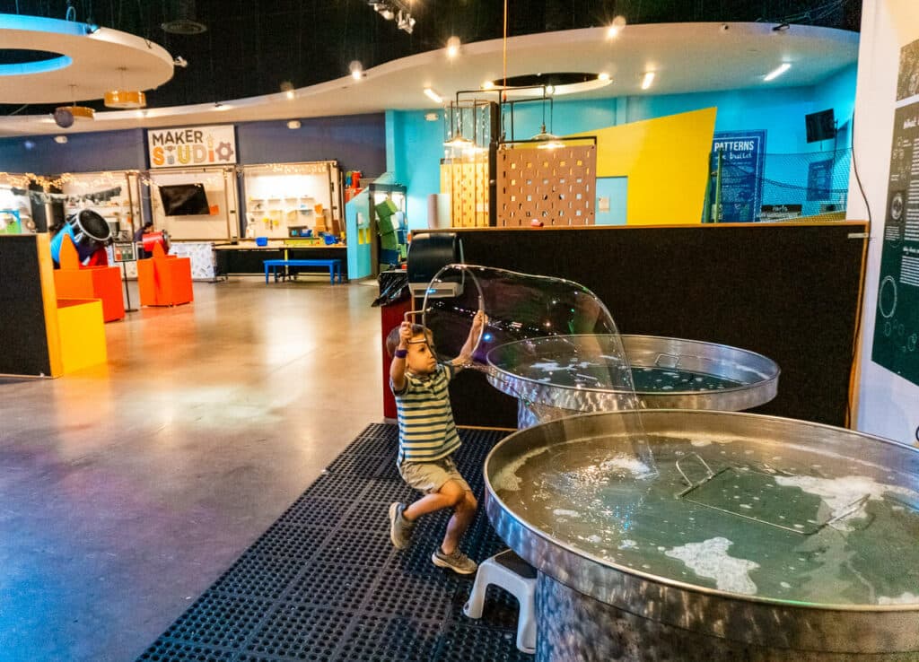 A young boy making a huge bubble at Sci-Tech Discovery Center in Frisco, Texas.