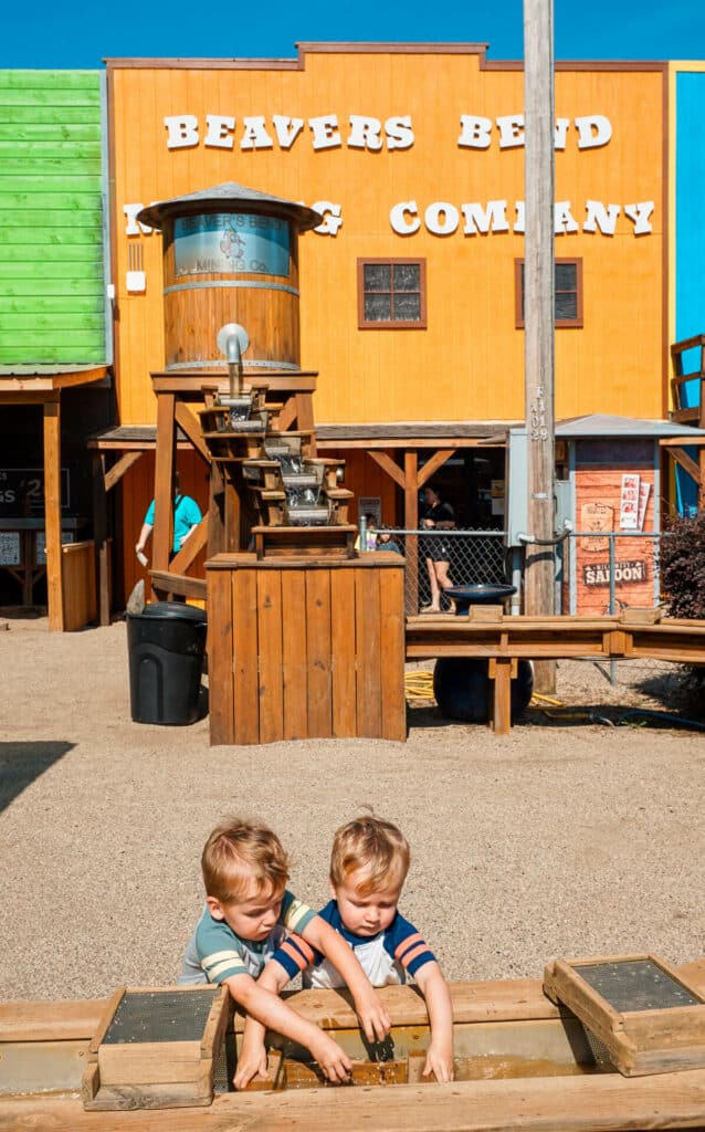 Twin boys panning for fossils at Beavers Bend Mining Company in Broken Bow. 