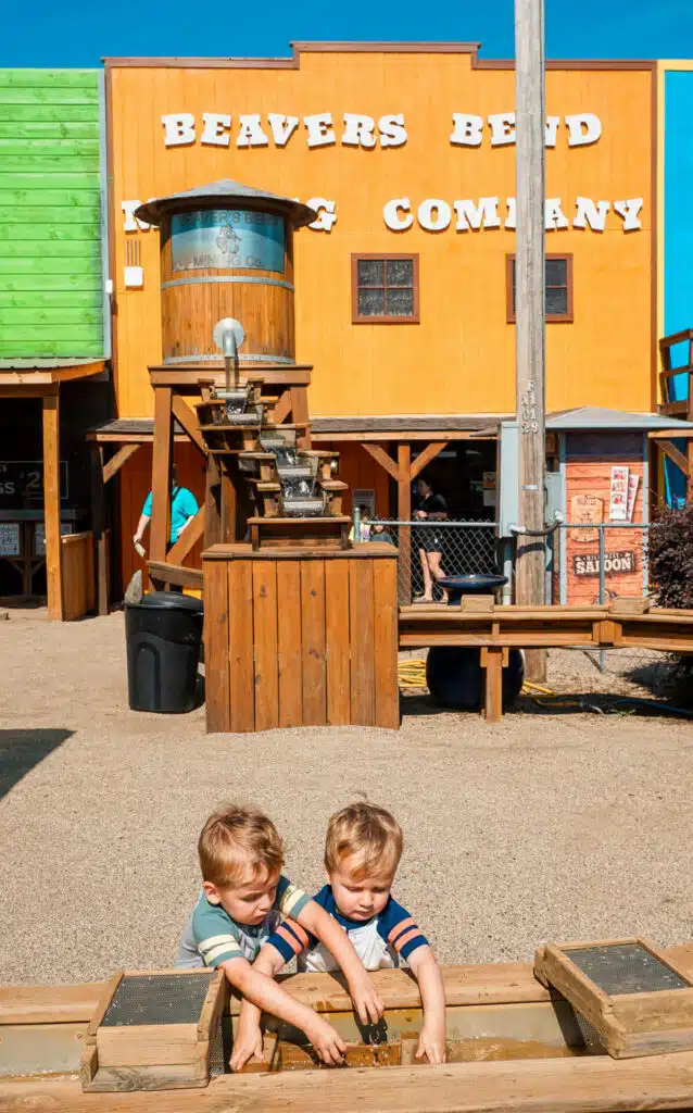 Twin boys panning for fossils at Beavers Bend Mining Company in Broken Bow. 