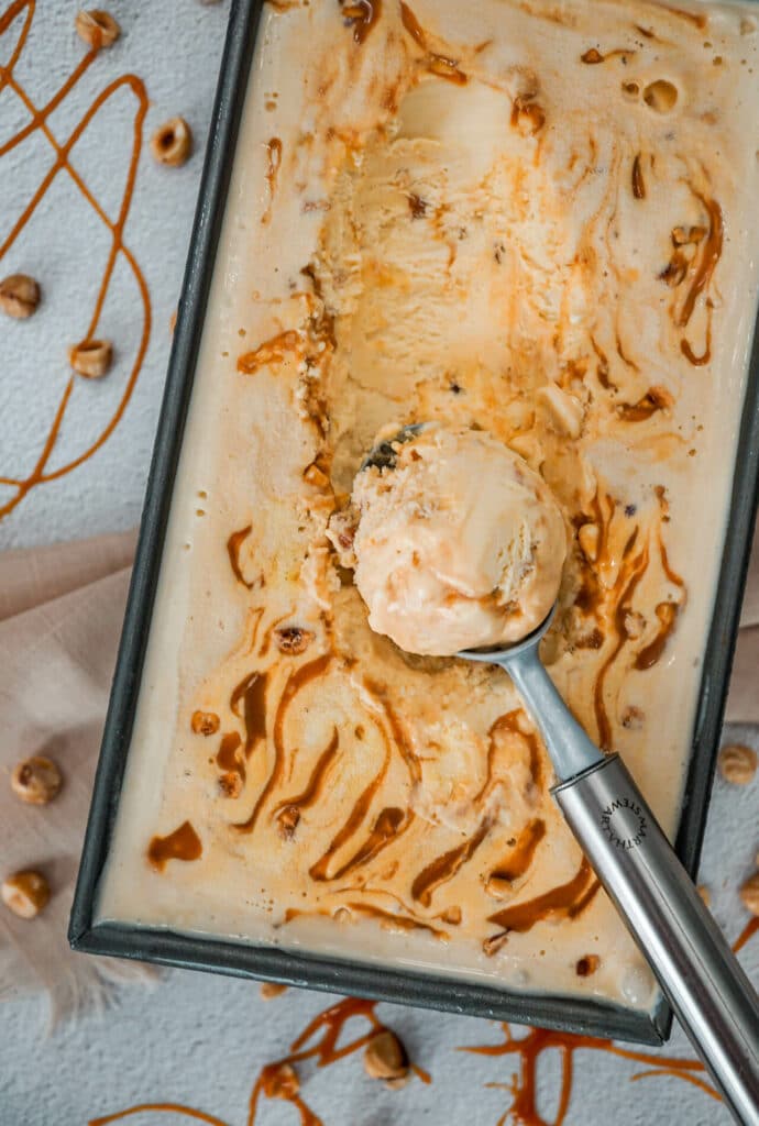 A rectangle pan filled with homemade Hazelnut Salted Caramel Ice Cream inspired by Tillamook. 