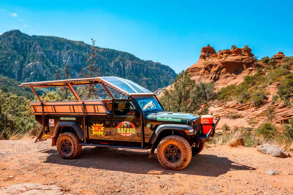 A Jeep Gladiator from Arizona Safari Jeep Tours with Merry-Go-Rock in the background. This Jeep tour is one of the best things to add to your 3-day Sedona Itinerary. 